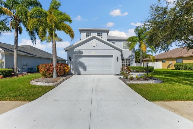 view of property featuring a front lawn and a garage