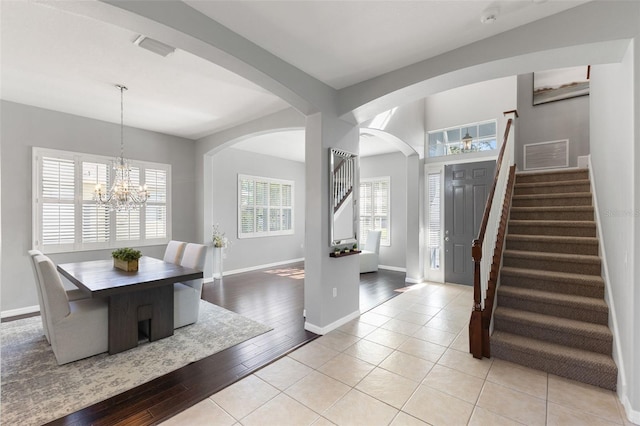 foyer entrance featuring light wood-type flooring and an inviting chandelier