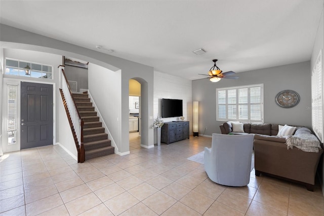 unfurnished living room featuring ceiling fan and light tile patterned flooring