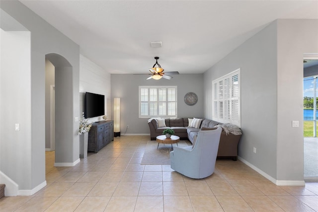 tiled living room featuring a wealth of natural light and ceiling fan