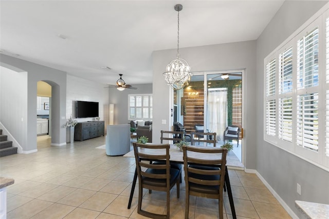 tiled dining area featuring a notable chandelier and plenty of natural light