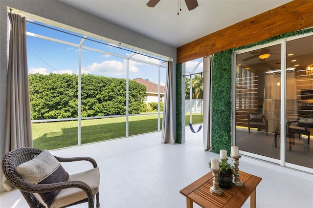 sunroom / solarium featuring ceiling fan