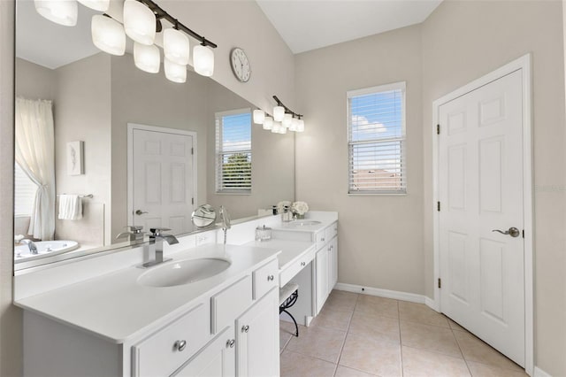 bathroom with tile patterned floors, plenty of natural light, and vanity