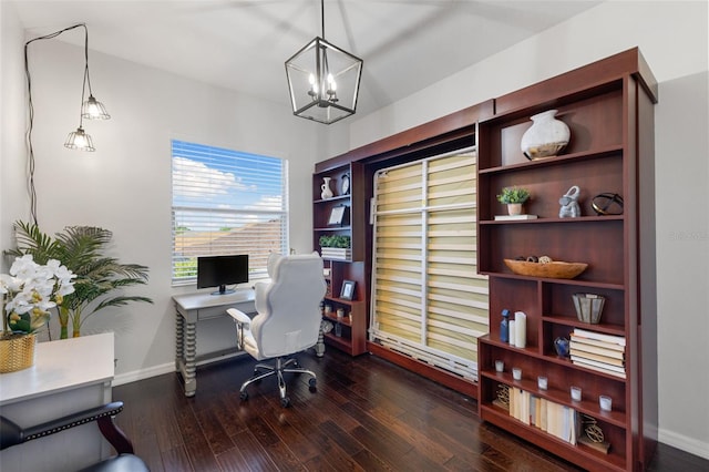 office area with dark hardwood / wood-style floors and an inviting chandelier