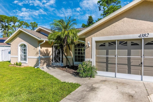 single story home with a front yard and a garage