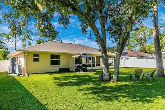 rear view of property with a yard