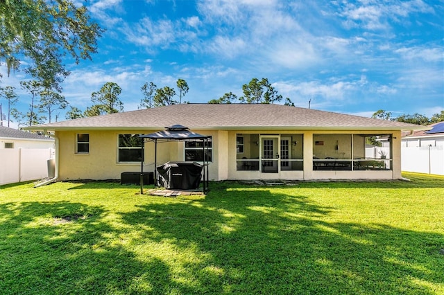 back of property featuring a yard