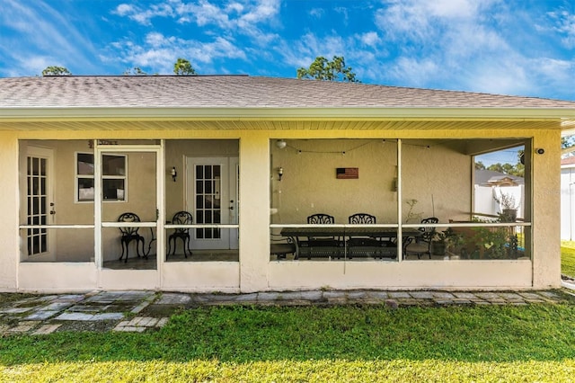 rear view of house with a patio and a yard