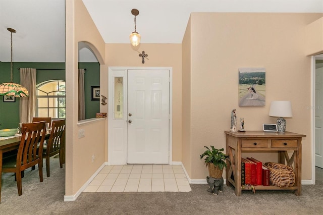 view of carpeted foyer entrance