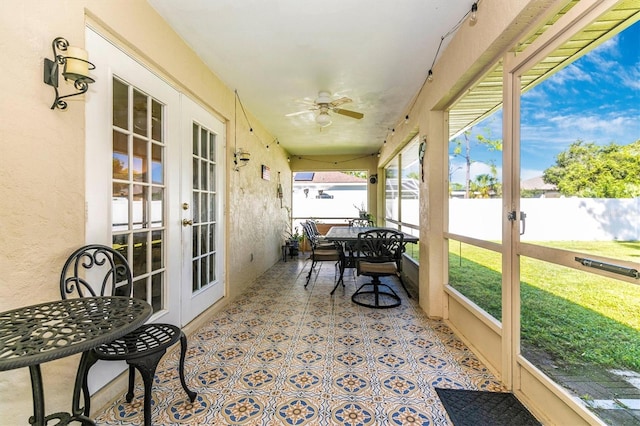 sunroom / solarium with ceiling fan and french doors