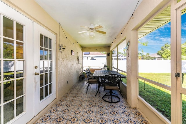 sunroom / solarium with ceiling fan and french doors