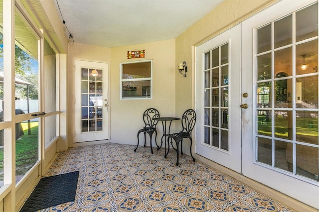 sunroom with a wealth of natural light and french doors