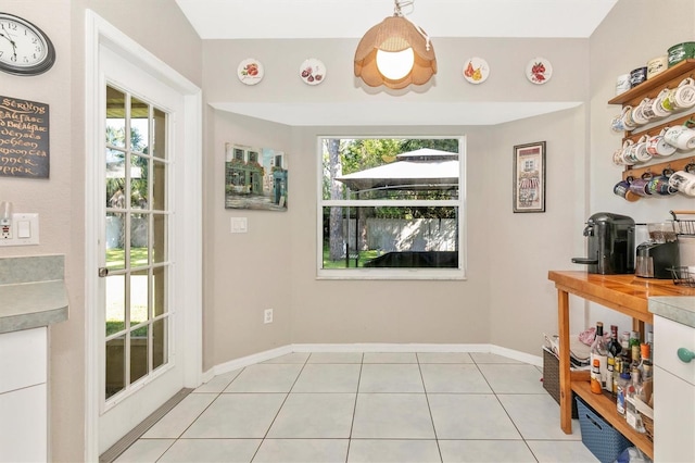 tiled dining room featuring a healthy amount of sunlight