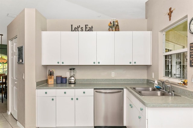 kitchen with white cabinets, dishwasher, sink, and light tile patterned flooring