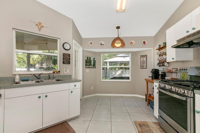 kitchen with pendant lighting, sink, white cabinetry, stainless steel gas range oven, and vaulted ceiling