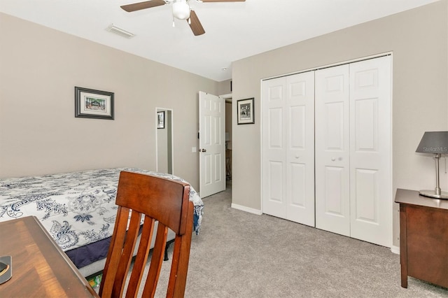 carpeted bedroom with a closet and ceiling fan