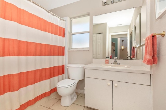 bathroom with walk in shower, vanity, tile patterned flooring, and toilet