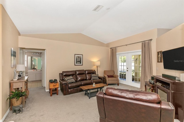 carpeted living room featuring french doors and vaulted ceiling