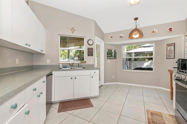 kitchen with a healthy amount of sunlight, stainless steel appliances, white cabinetry, and decorative light fixtures