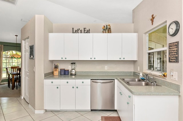 kitchen with light tile patterned flooring, hanging light fixtures, sink, white cabinetry, and dishwasher