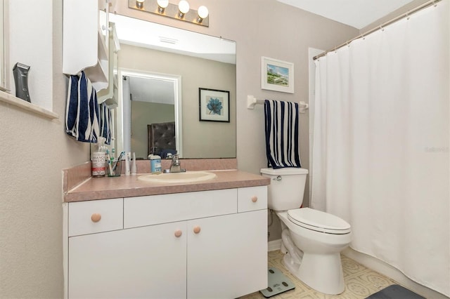 bathroom with tile patterned floors, vanity, and toilet