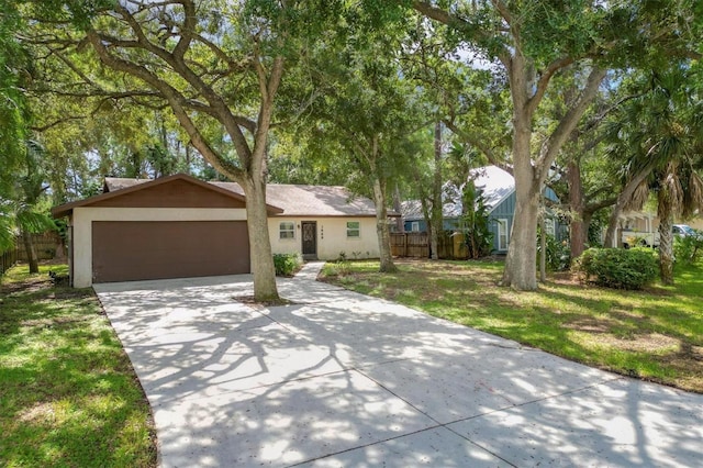 ranch-style house featuring a front yard and a garage