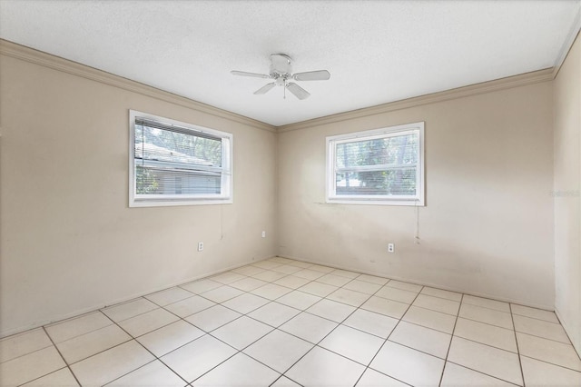 tiled empty room with ceiling fan, a textured ceiling, plenty of natural light, and crown molding