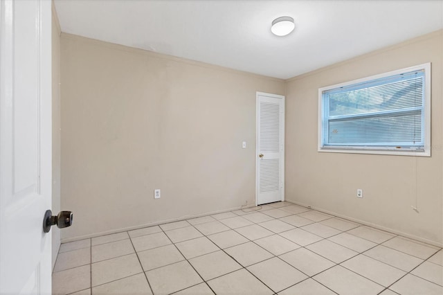 tiled empty room with ornamental molding