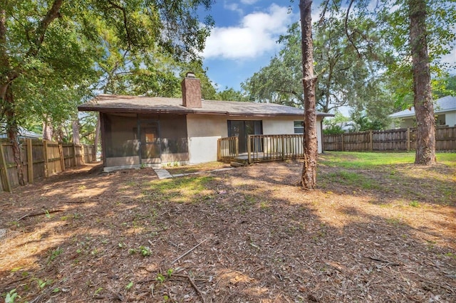 rear view of property with a sunroom