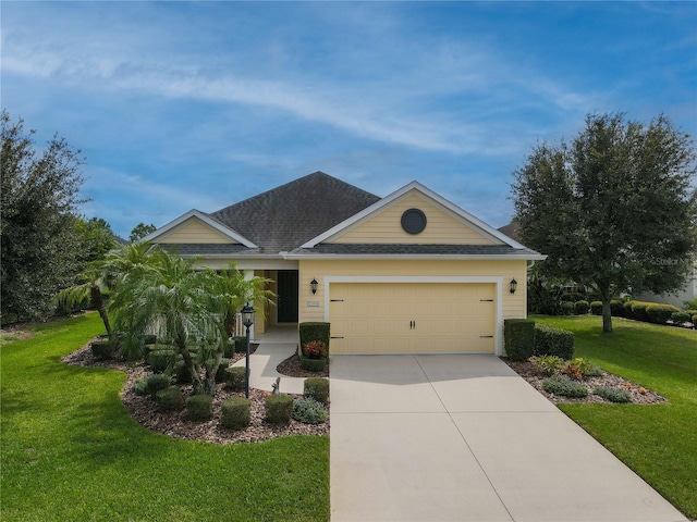 single story home featuring a garage and a front lawn