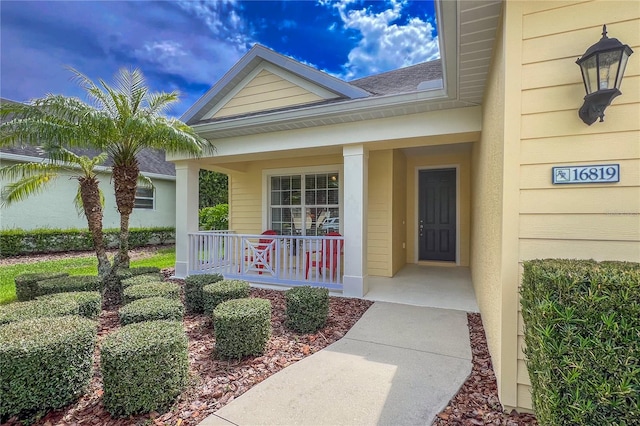 property entrance with covered porch