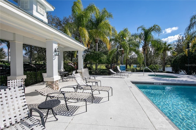 view of swimming pool with a community hot tub and a patio