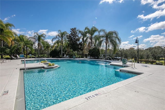 view of pool with pool water feature and a patio area