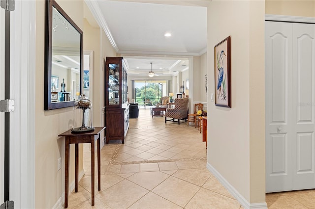 hallway featuring crown molding and light tile patterned floors