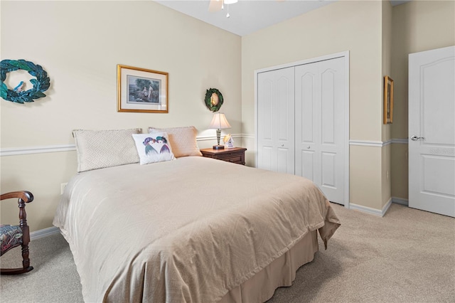 carpeted bedroom featuring ceiling fan and a closet