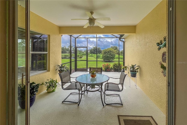 sunroom with a wealth of natural light and ceiling fan