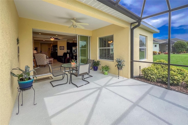 sunroom featuring ceiling fan