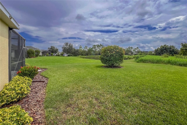 view of yard featuring a lanai