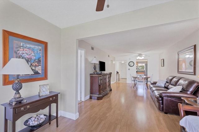 living room featuring light wood-type flooring and ceiling fan