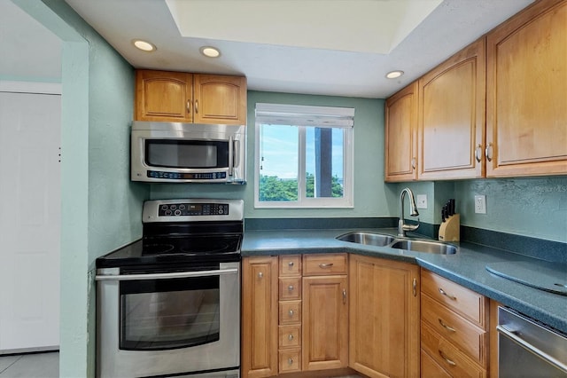 kitchen featuring sink, light tile patterned floors, and stainless steel appliances