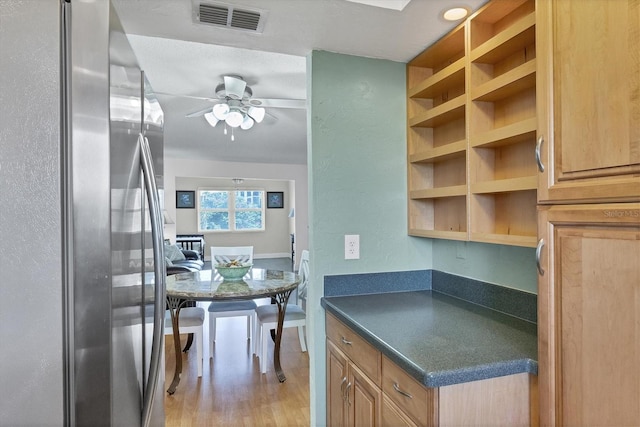 kitchen featuring stainless steel fridge, light hardwood / wood-style flooring, and ceiling fan