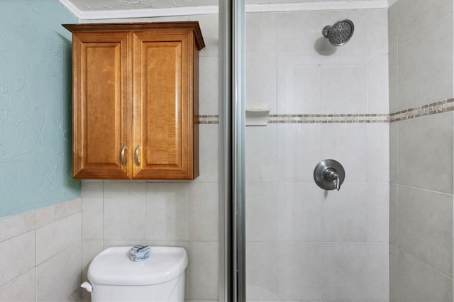 bathroom with an enclosed shower, ornamental molding, and tile walls