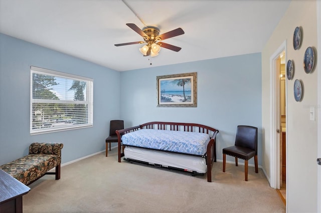 bedroom featuring light colored carpet and ceiling fan