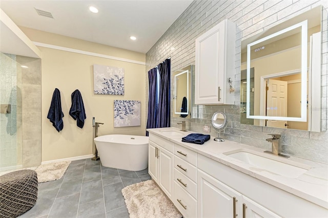 bathroom with vanity, tile patterned flooring, a washtub, and decorative backsplash