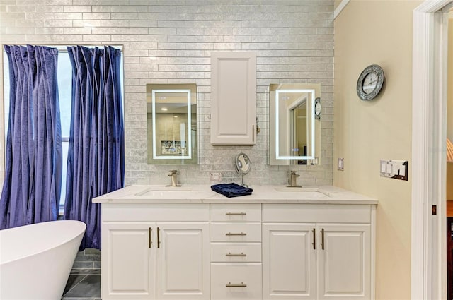 bathroom with a washtub and vanity