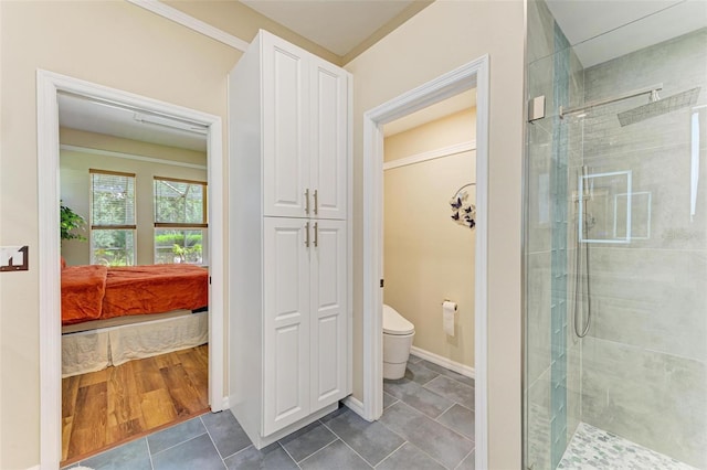 bathroom featuring walk in shower, toilet, and wood-type flooring