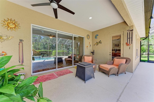 view of patio / terrace featuring a lanai and ceiling fan