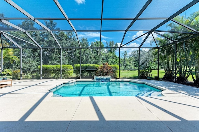 view of pool with a patio, a lanai, and pool water feature