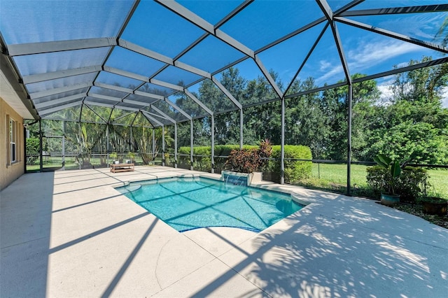 view of pool with glass enclosure and a patio area