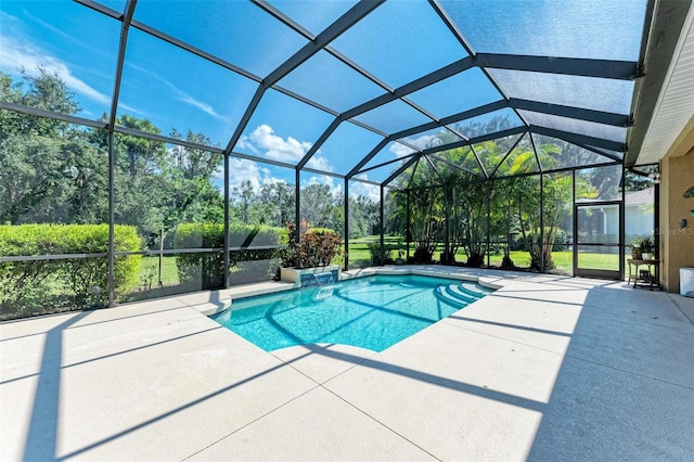 view of swimming pool with glass enclosure and a patio area